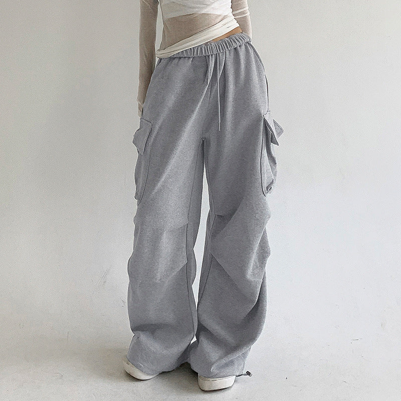 Pantalones deportivos plisados ​​con bolsillos de color liso